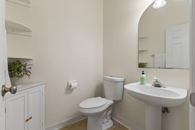 1235 SW Briarwood Dr, Port Saint Lucie, FL 34986 - half bathroom with baseboards, toilet, and tile patterned floors