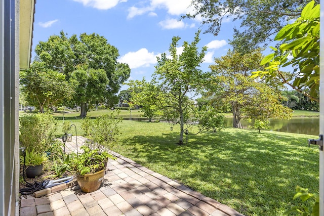 1235 SW Briarwood Dr, Port Saint Lucie, FL 34986 - view of grassy yard with a water view and a patio