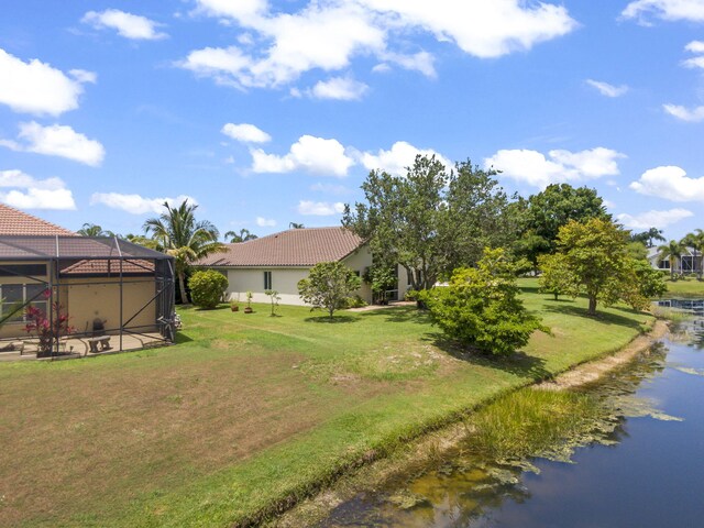1235 SW Briarwood Dr, Port Saint Lucie, FL 34986 - view of green lawn with a water view and glass enclosure