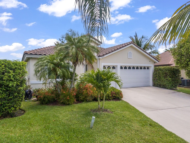 1235 SW Briarwood Dr, Port Saint Lucie, FL 34986 - mediterranean / spanish house with a tile roof, stucco siding, driveway, a front lawn, and a garage