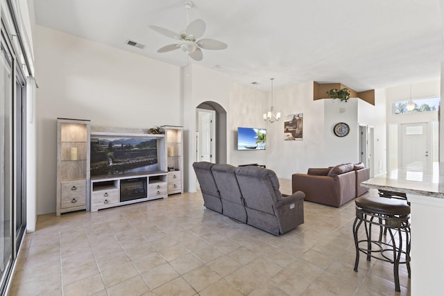 1235 SW Briarwood Dr, Port Saint Lucie, FL 34986 - living area featuring arched walkways, a ceiling fan, a chandelier, and light tile patterned floors