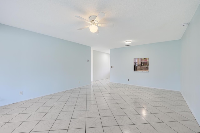 unfurnished room featuring a textured ceiling and a ceiling fan