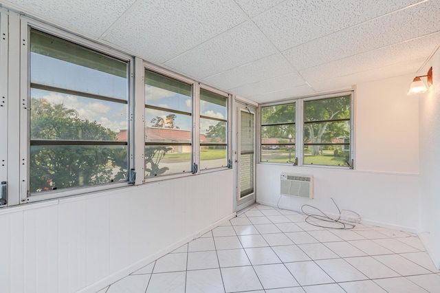 unfurnished sunroom with a wall mounted AC