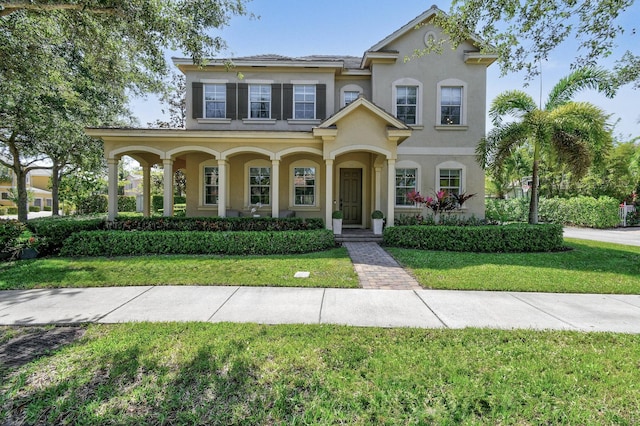 111 Tullamore Ave, Jupiter, FL 33458 - view of front of house with stucco siding, a front lawn, and a porch