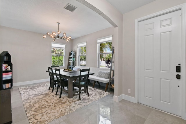 111 Tullamore Ave, Jupiter, FL 33458 - dining area with arched walkways, a chandelier, and baseboards