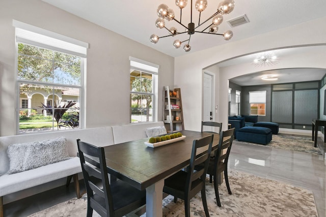 111 Tullamore Ave, Jupiter, FL 33458 - dining room with arched walkways and a chandelier