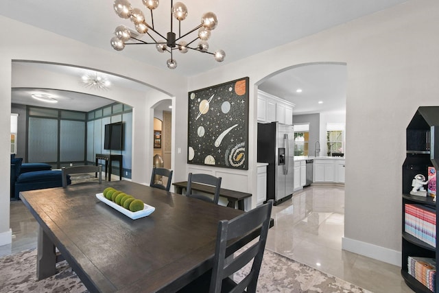 111 Tullamore Ave, Jupiter, FL 33458 - dining space with arched walkways, a chandelier, and baseboards