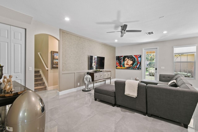 111 Tullamore Ave, Jupiter, FL 33458 - living area with arched walkways, ceiling fan, stairway, recessed lighting, and a wainscoted wall
