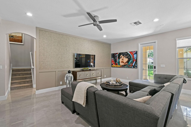111 Tullamore Ave, Jupiter, FL 33458 - living room featuring arched walkways, a decorative wall, a ceiling fan, stairs, and recessed lighting
