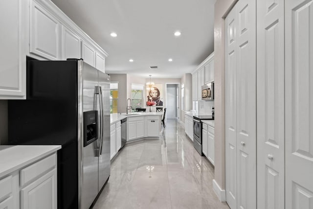 111 Tullamore Ave, Jupiter, FL 33458 - kitchen with stainless steel appliances, a sink, recessed lighting, white cabinetry, and light countertops