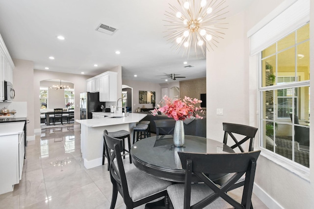 111 Tullamore Ave, Jupiter, FL 33458 - dining space with a chandelier, arched walkways, recessed lighting, baseboards, and light marble finish floors