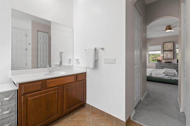 111 Tullamore Ave, Jupiter, FL 33458 - bathroom with vanity, ceiling fan, connected bathroom, baseboards, and tile patterned floors