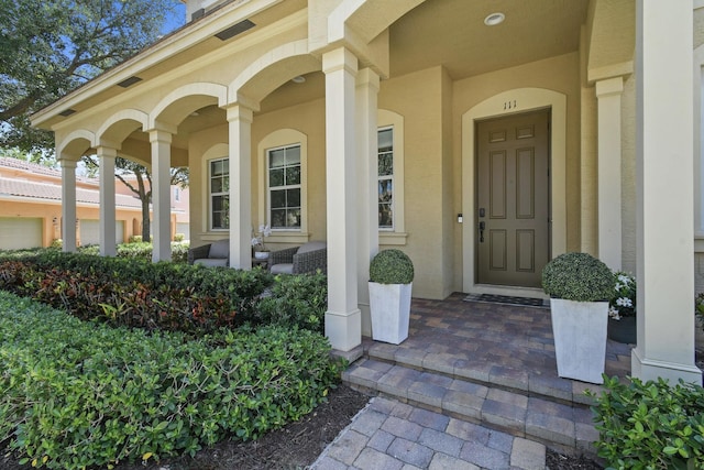 111 Tullamore Ave, Jupiter, FL 33458 - view of exterior entry featuring covered porch and stucco siding
