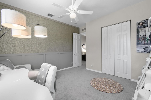 111 Tullamore Ave, Jupiter, FL 33458 - bedroom with carpet flooring, a closet, a decorative wall, wainscoting, and ceiling fan