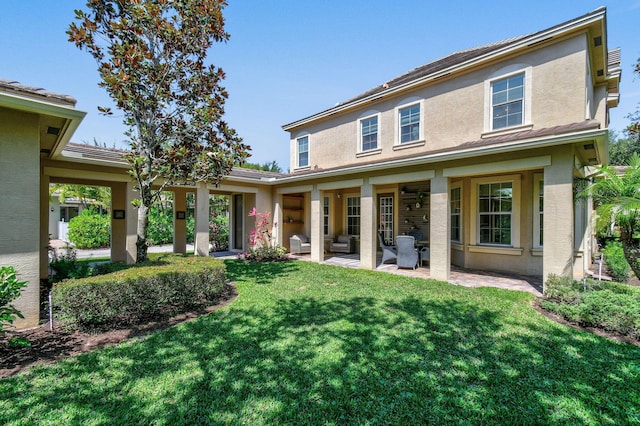 111 Tullamore Ave, Jupiter, FL 33458 - back of property with stucco siding, a lawn, an outdoor hangout area, and a patio area