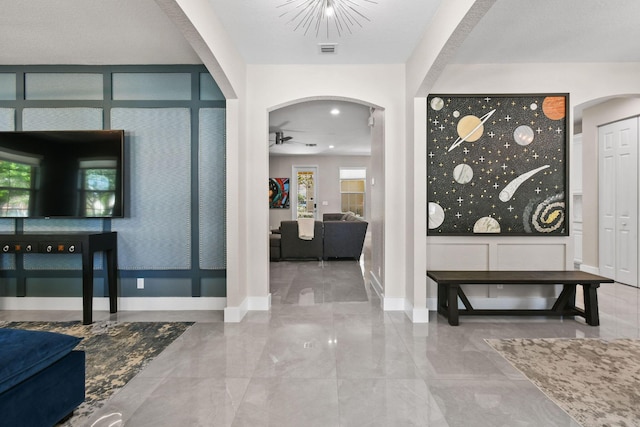 111 Tullamore Ave, Jupiter, FL 33458 - foyer entrance with arched walkways, ceiling fan, marble finish flooring, and baseboards