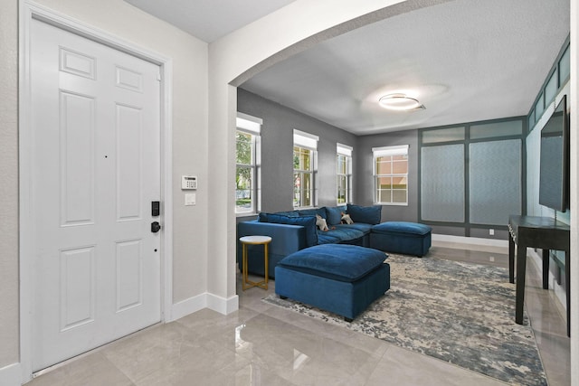 111 Tullamore Ave, Jupiter, FL 33458 - foyer with arched walkways, baseboards, and a textured ceiling