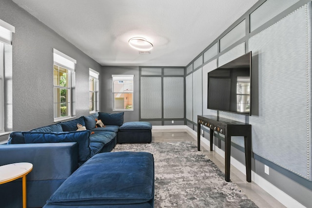 111 Tullamore Ave, Jupiter, FL 33458 - living area with wood finished floors, a textured wall, and baseboards
