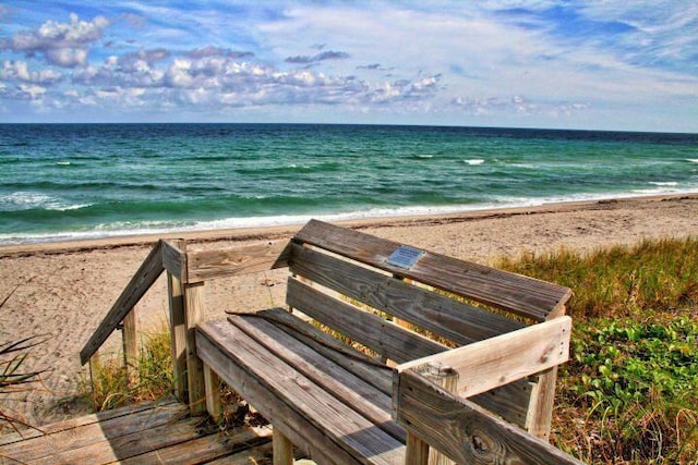 view of home's community featuring view of water and beach