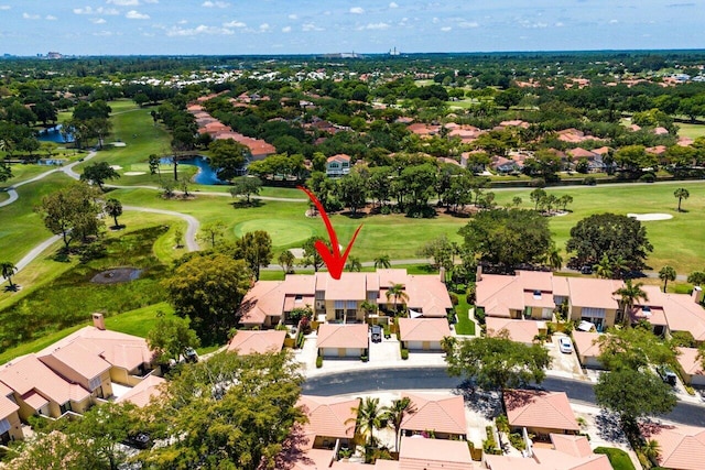aerial perspective of suburban area featuring a golf course and a nearby body of water