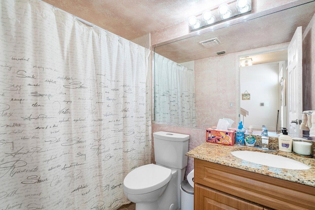 bathroom featuring vanity, toilet, and curtained shower