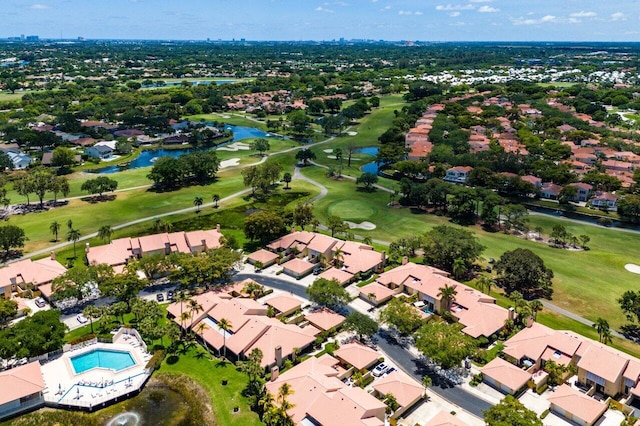 aerial view of residential area featuring a golf club and a nearby body of water