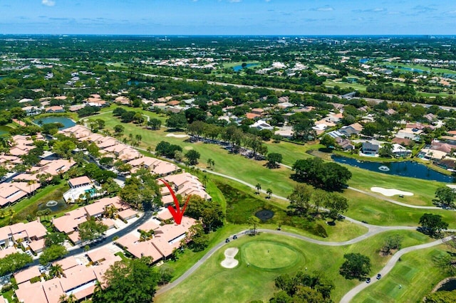 aerial overview of property's location featuring nearby suburban area, a nearby body of water, and a local golf course