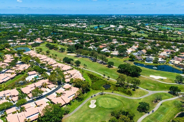 aerial overview of property's location featuring nearby suburban area, a large body of water, and a golf course