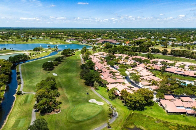 aerial view of property's location featuring a large body of water, nearby suburban area, and a local golf course