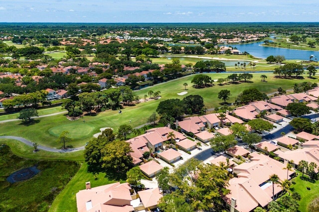aerial view of residential area with a large body of water and a local golf course