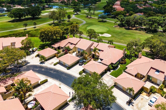aerial perspective of suburban area with a nearby body of water and a golf club