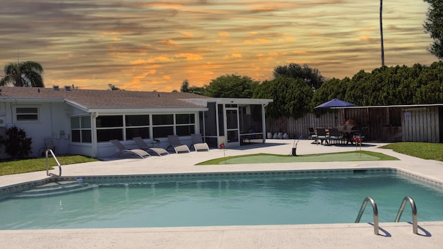 764 Westwind Dr, North Palm Beach, FL 33408 - view of swimming pool featuring a sunroom, a patio, and fence