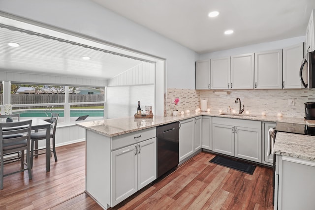 764 Westwind Dr, North Palm Beach, FL 33408 - kitchen featuring a sink, stainless steel dishwasher, a peninsula, light wood-style flooring, and decorative backsplash