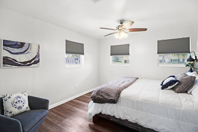 764 Westwind Dr, North Palm Beach, FL 33408 - bedroom featuring hardwood / wood-style flooring, baseboards, and ceiling fan