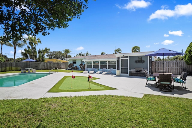 764 Westwind Dr, North Palm Beach, FL 33408 - view of pool with a putting green, a sunroom, and a patio area