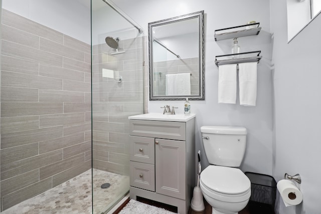 764 Westwind Dr, North Palm Beach, FL 33408 - full bathroom with a tile shower, toilet, and vanity