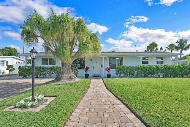 764 Westwind Dr, North Palm Beach, FL 33408 - ranch-style house featuring a front yard