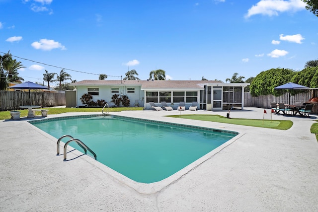 764 Westwind Dr, North Palm Beach, FL 33408 - view of pool featuring a sunroom, a patio, and a fenced backyard