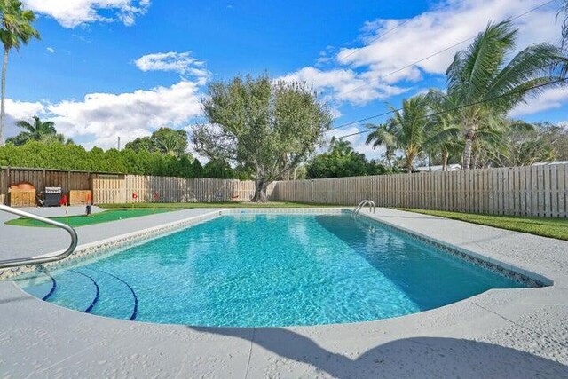 764 Westwind Dr, North Palm Beach, FL 33408 - view of swimming pool featuring a fenced backyard and a patio
