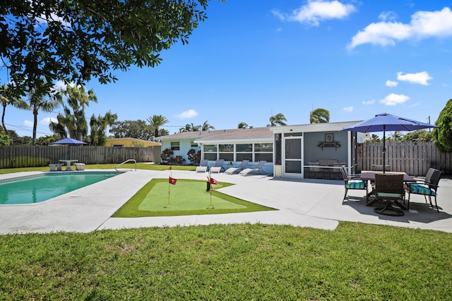 764 Westwind Dr, North Palm Beach, FL 33408 - view of pool with a putting area, a sunroom, and a patio area