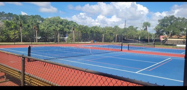 764 Westwind Dr, North Palm Beach, FL 33408 - view of tennis court featuring fence
