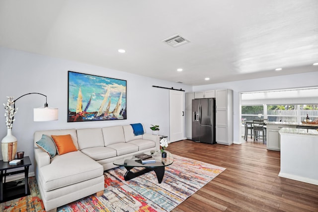 764 Westwind Dr, North Palm Beach, FL 33408 - living room with a barn door, wood finished floors, recessed lighting, and baseboards