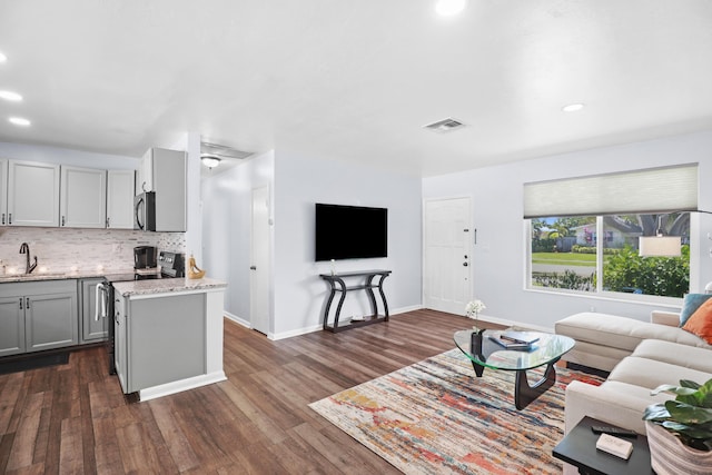 764 Westwind Dr, North Palm Beach, FL 33408 - living room with dark wood-style flooring, recessed lighting, and baseboards