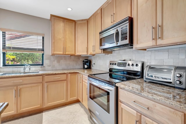 8030 Eastlake Dr Unit 10B, Boca Raton, FL 33433 - kitchen featuring appliances with stainless steel finishes, light brown cabinets, a sink, decorative backsplash, and recessed lighting