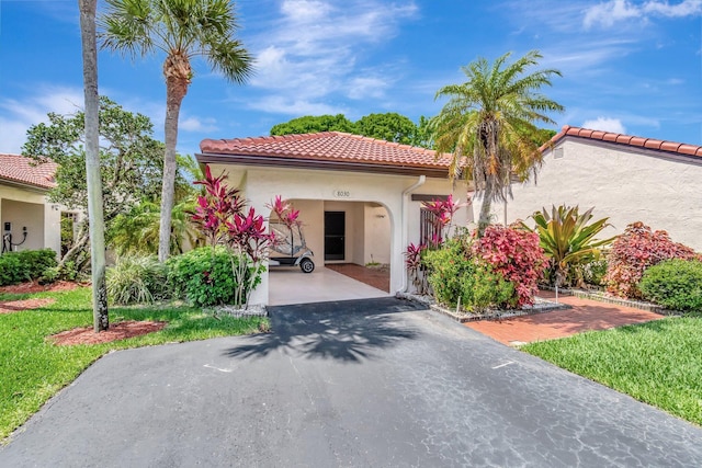 8030 Eastlake Dr Unit 10B, Boca Raton, FL 33433 - mediterranean / spanish house featuring asphalt driveway, stucco siding, a tile roof, and a carport