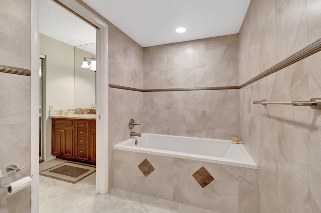 8030 Eastlake Dr Unit 10B, Boca Raton, FL 33433 - bathroom with tiled tub, marble finish flooring, and vanity