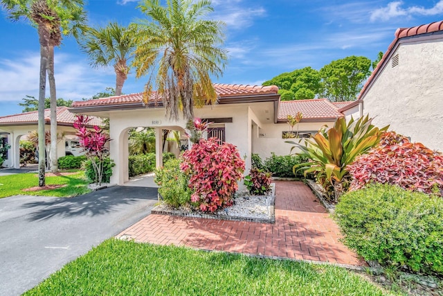 8030 Eastlake Dr Unit 10B, Boca Raton, FL 33433 - mediterranean / spanish house featuring a tiled roof, stucco siding, and driveway