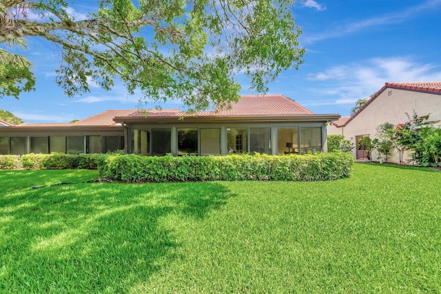 8030 Eastlake Dr Unit 10B, Boca Raton, FL 33433 - back of house featuring a tiled roof, a sunroom, and a lawn