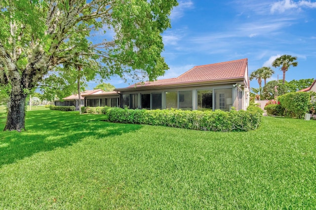 8030 Eastlake Dr Unit 10B, Boca Raton, FL 33433 - back of property with a tile roof, a yard, and a sunroom