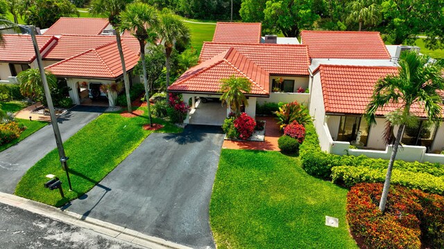 8030 Eastlake Dr Unit 10B, Boca Raton, FL 33433 - mediterranean / spanish house with a tiled roof, driveway, stucco siding, and a front yard